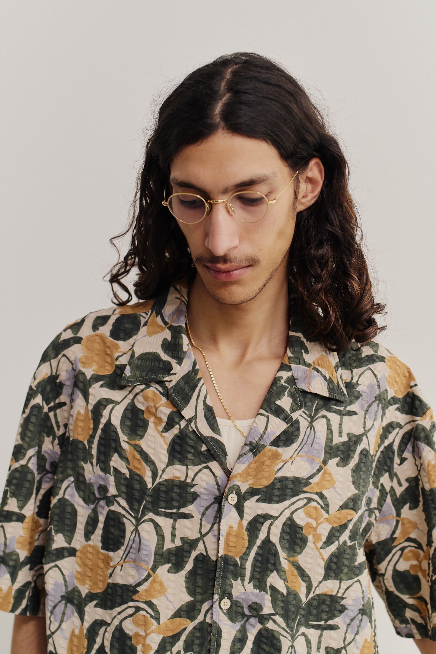 Men's short-sleeved shirt, cotton seersucker, floral print in green, purple, and gold.