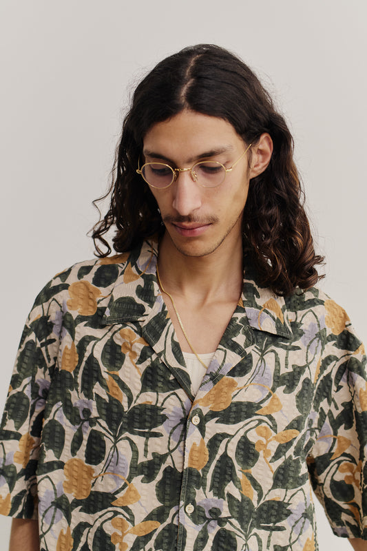 Men's short-sleeved shirt, cotton seersucker, floral print in green, purple, and gold.