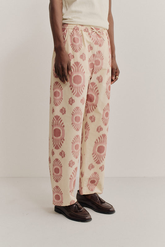 Men's long-pants, cotton and recycled polyester blend, ikat print, beige with red pattern, relaxed fit.