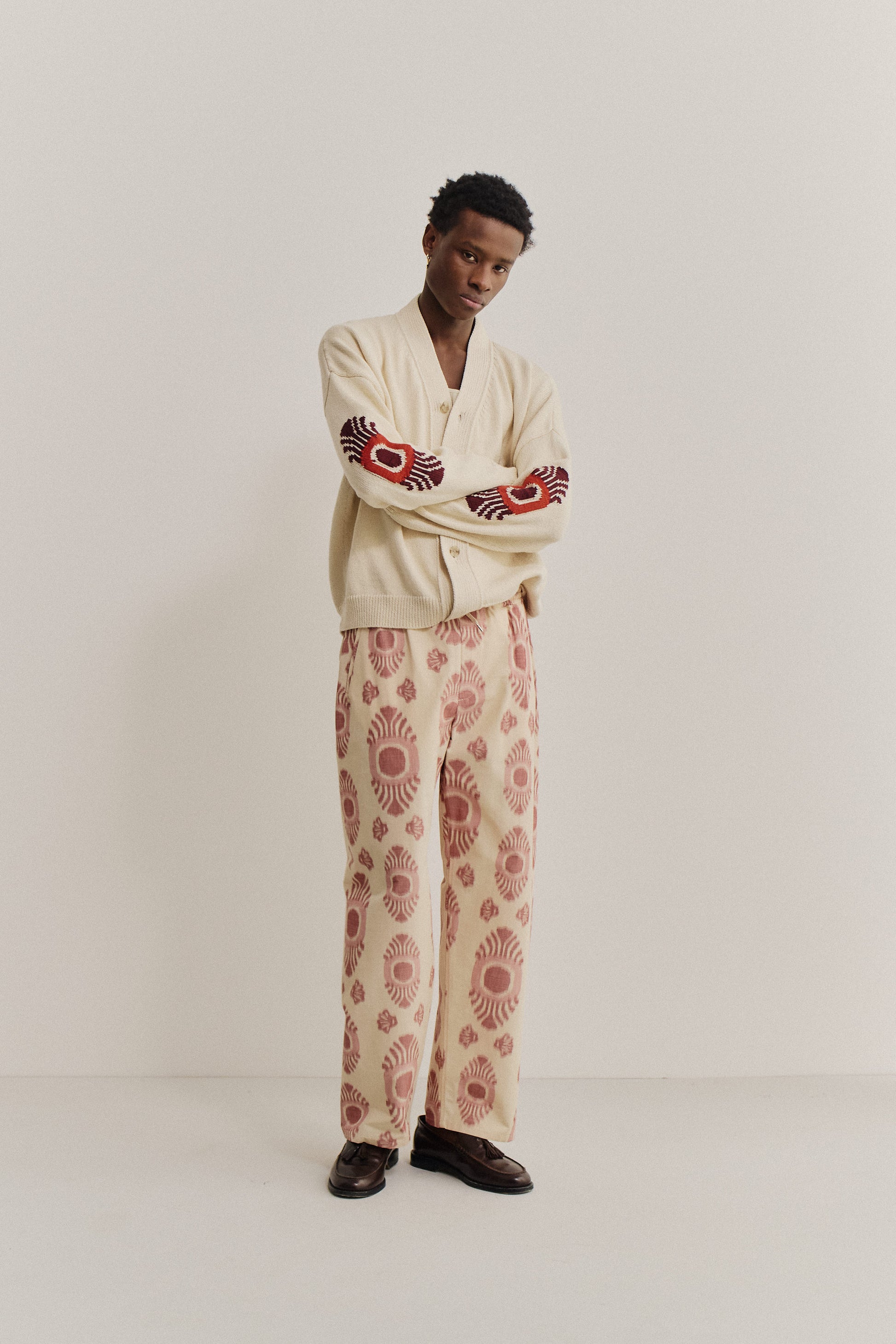 Men's long-pants, cotton and recycled polyester blend, ikat pattern, beige with red motif.