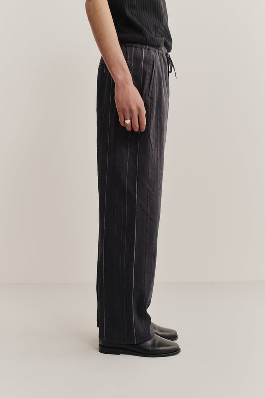 Men's long pants, cotton-linen blend, black with subtle white stripes, wide straight fit, elasticated waist.