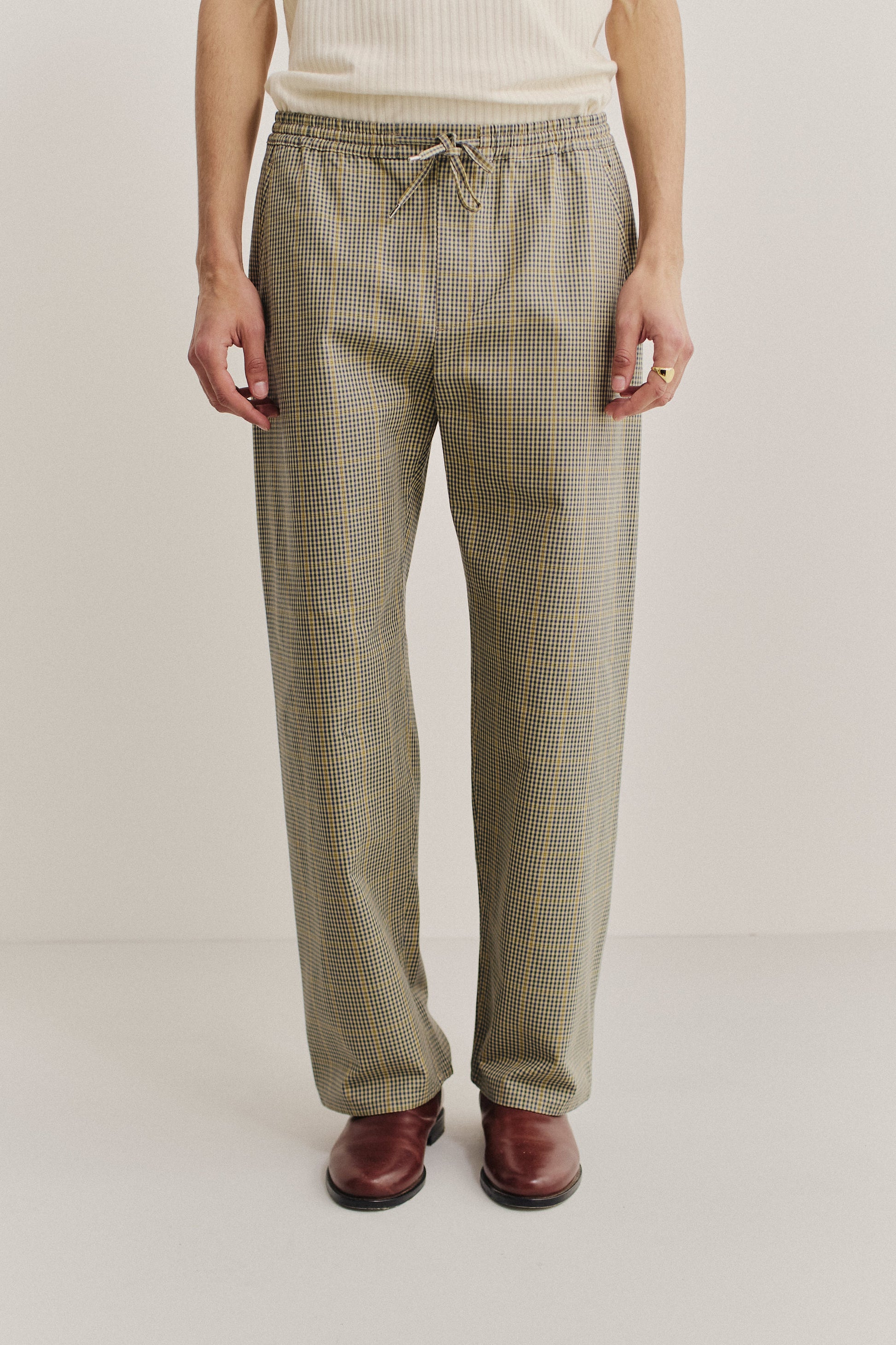 Men's long pants, cotton houndstooth in navy, green, and yellow on beige, with elastic waist.
