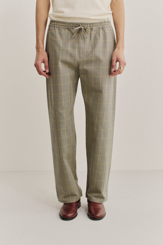 Men's long pants, cotton houndstooth in navy, green, and yellow on beige, with elastic waist.