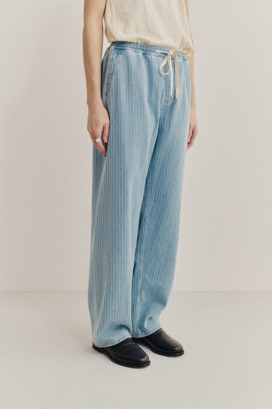 Men's long-pants, organic cotton, washed light blue denim with white pinstripes, elastic waist, wide leg.