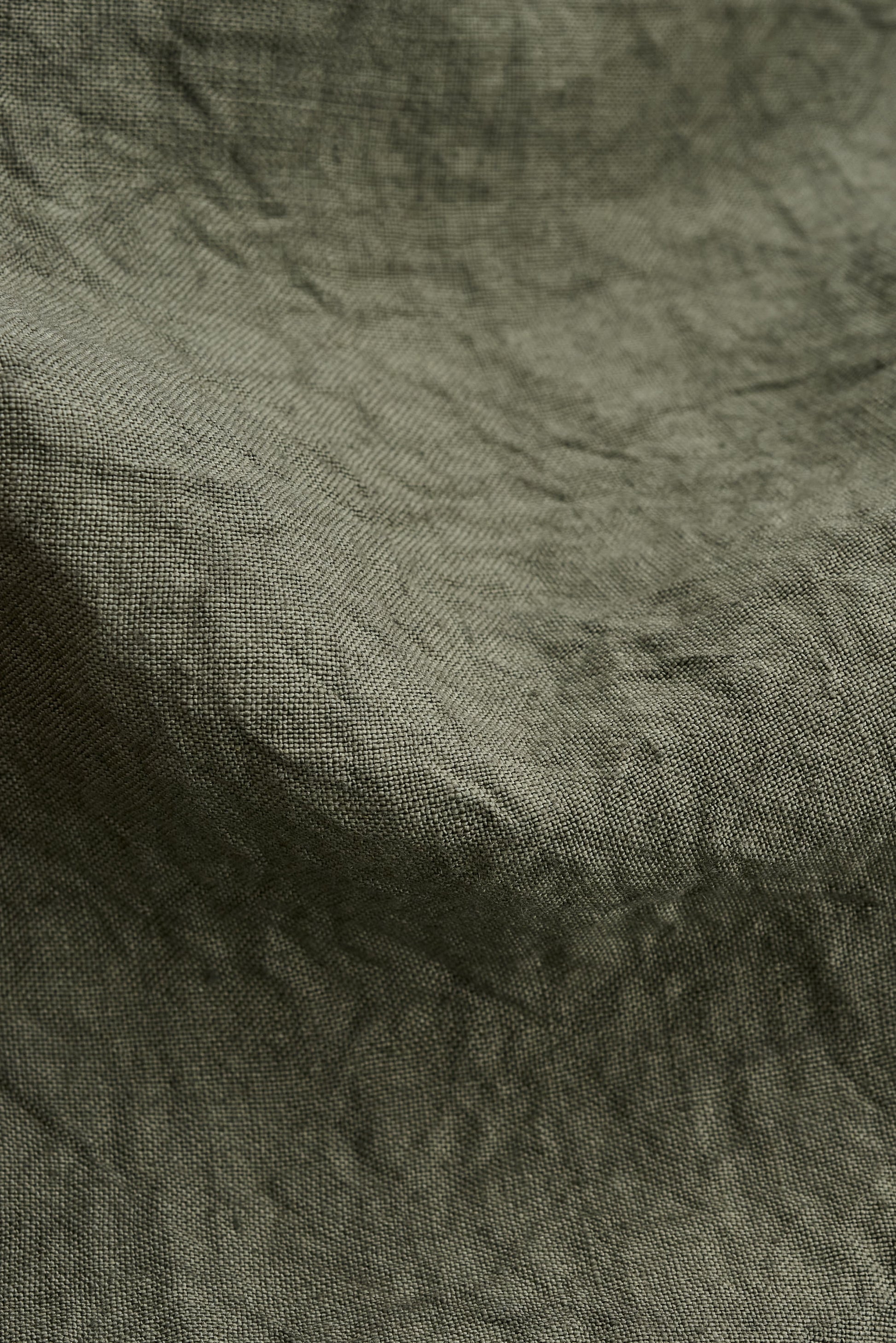 Men's long pants, Japanese linen, sun-dried, olive green, with subtle natural texture.
