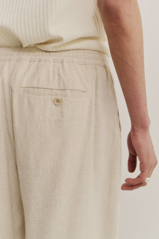 Unisex long-pants, linen silk blend, naturally textured, undyed, unbleached, with elastic waist and buttoned back pocket.
