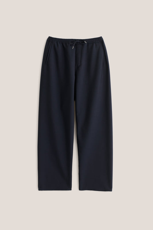 Unisex long-pants, 100% virgin wool, dark navy, wide straight fit, elasticated waistband, welt pockets.