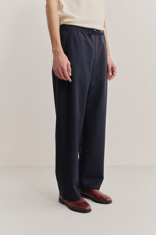 Unisex long-pants, 100% virgin wool, dark navy, wide straight fit, elasticated waistband, welt pockets.