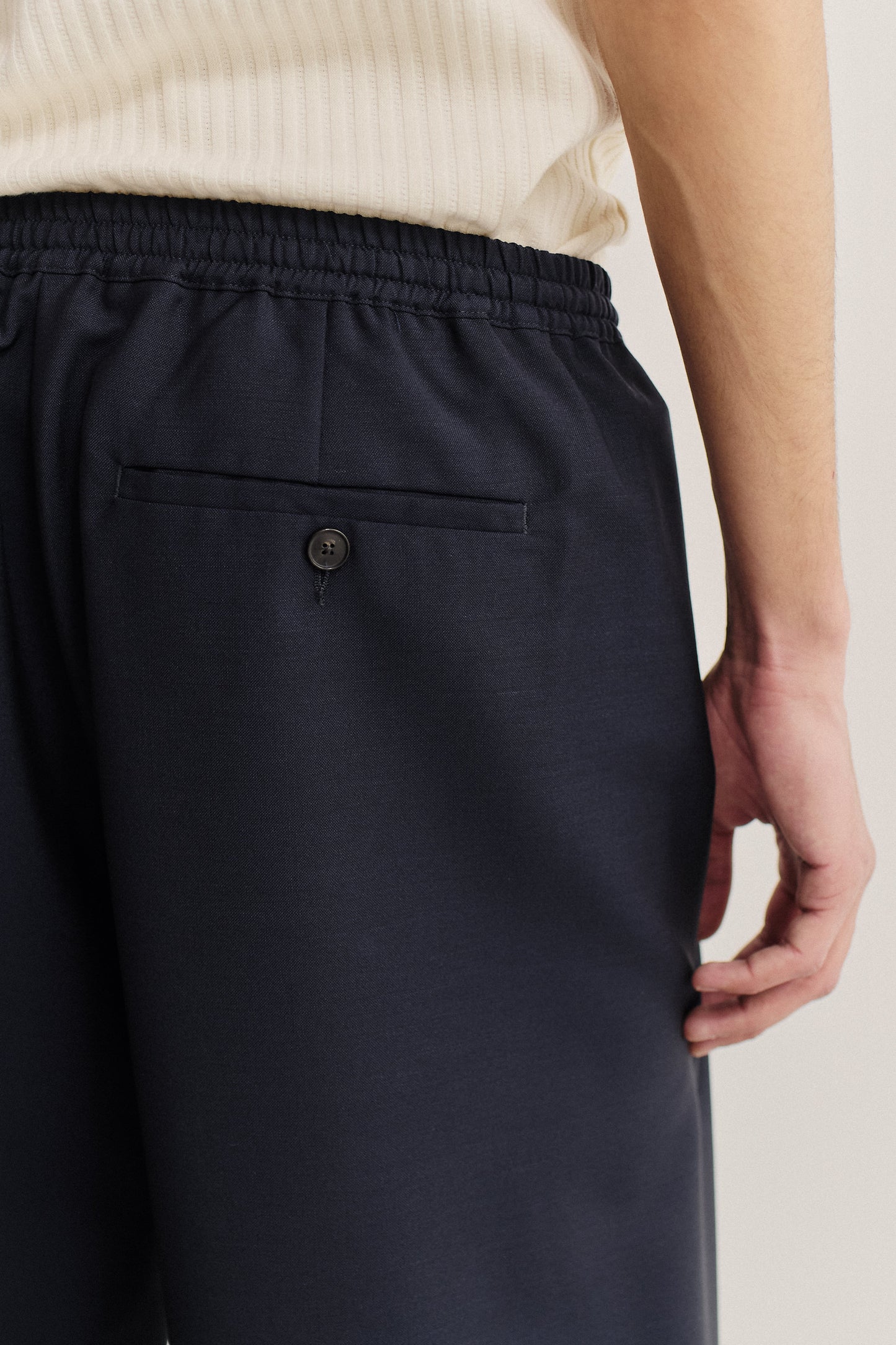Unisex long-pants, 100% virgin wool, dark navy, with elasticated waistband and back welt pocket.