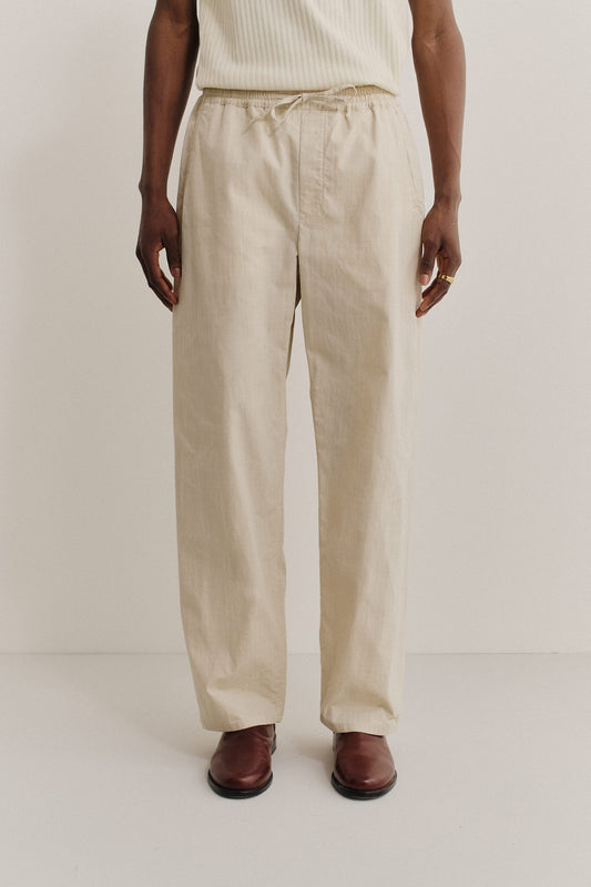 Men's long-pants, cotton blend ripstop, natural beige, with elastic waist and welt pockets.