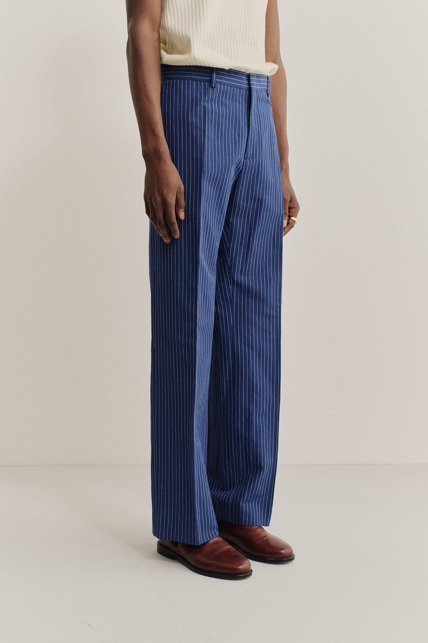 Men's long pants, cotton-linen seersucker, pinstriped navy, wide-leg cut, pressed front pleat.
