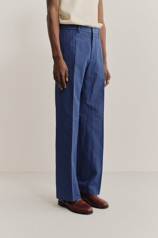 Men's long pants, cotton-linen seersucker, pinstriped navy, wide-leg cut, pressed front pleat.