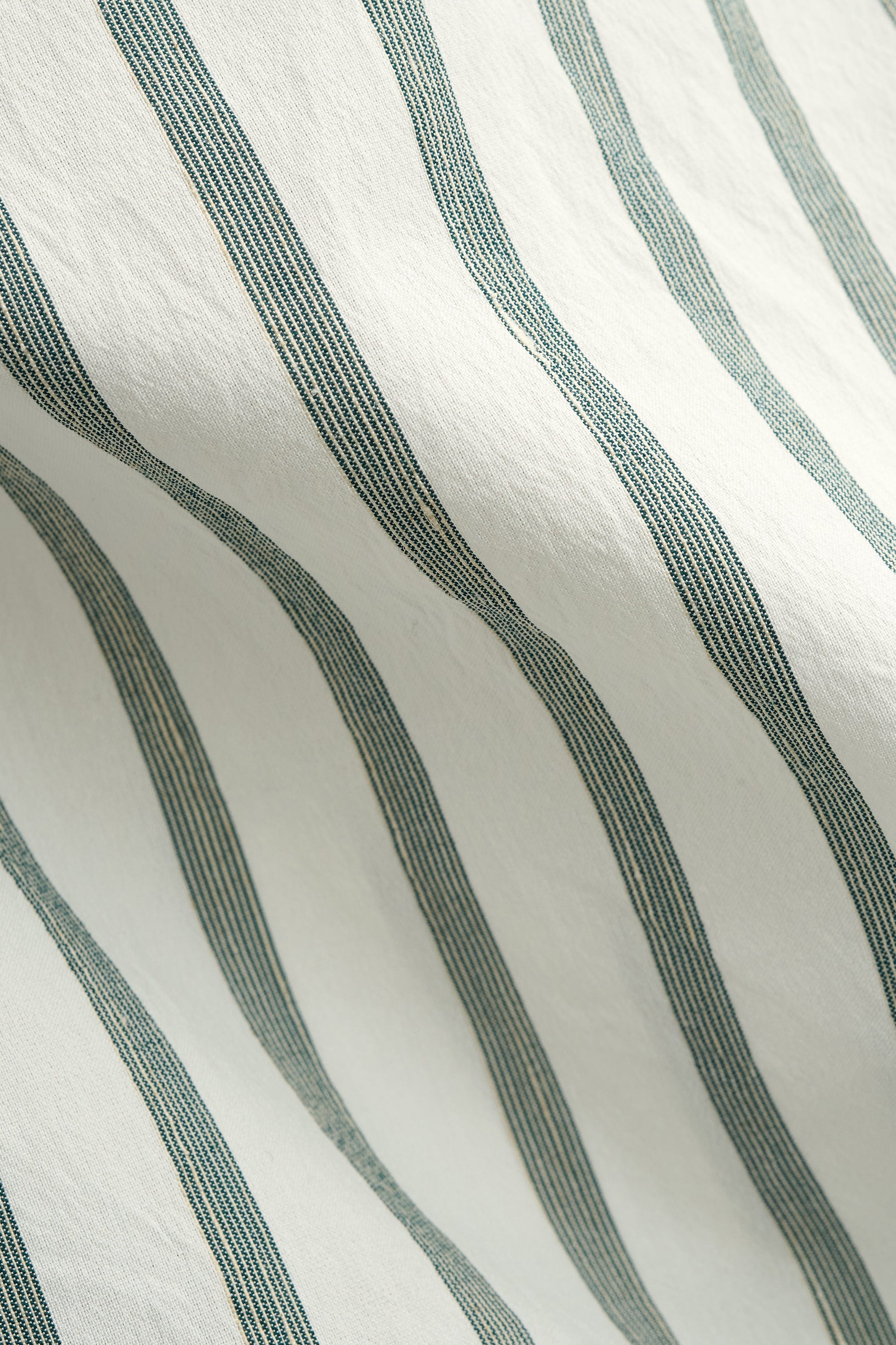 Men's short-sleeved shirt, cotton-silk-linen blend, washed finish, white with subtle green stripes.