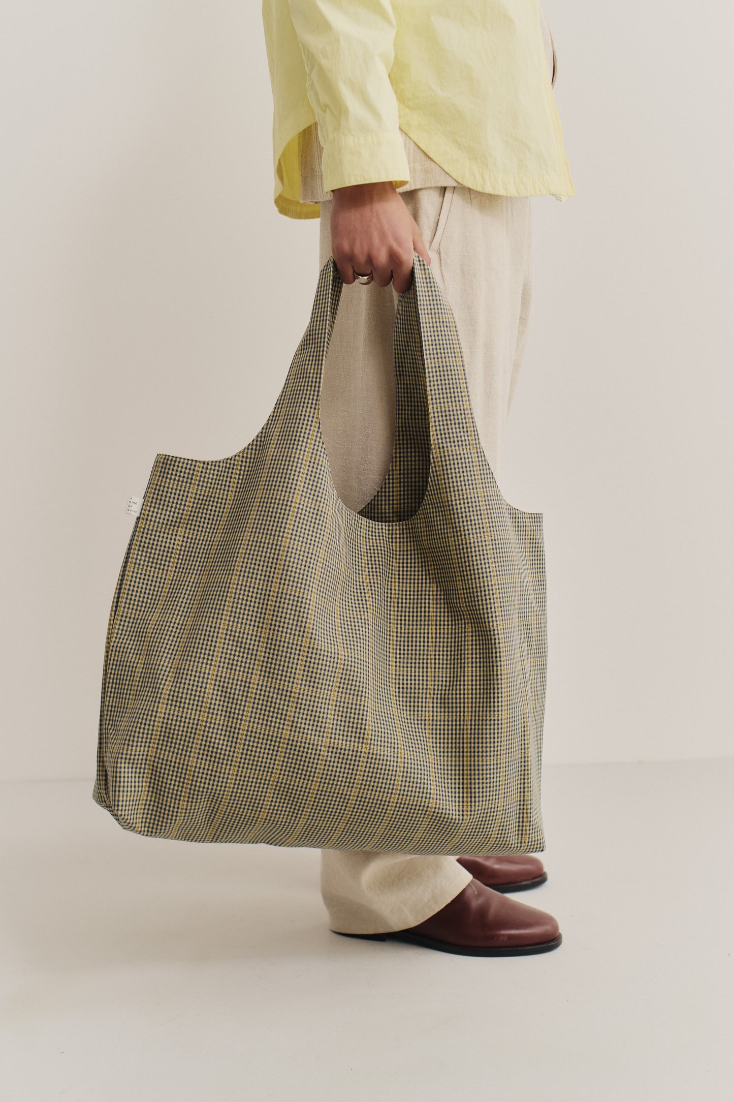 Women's accessories bag, cotton houndstooth in navy, green, and yellow on beige, spacious tote.