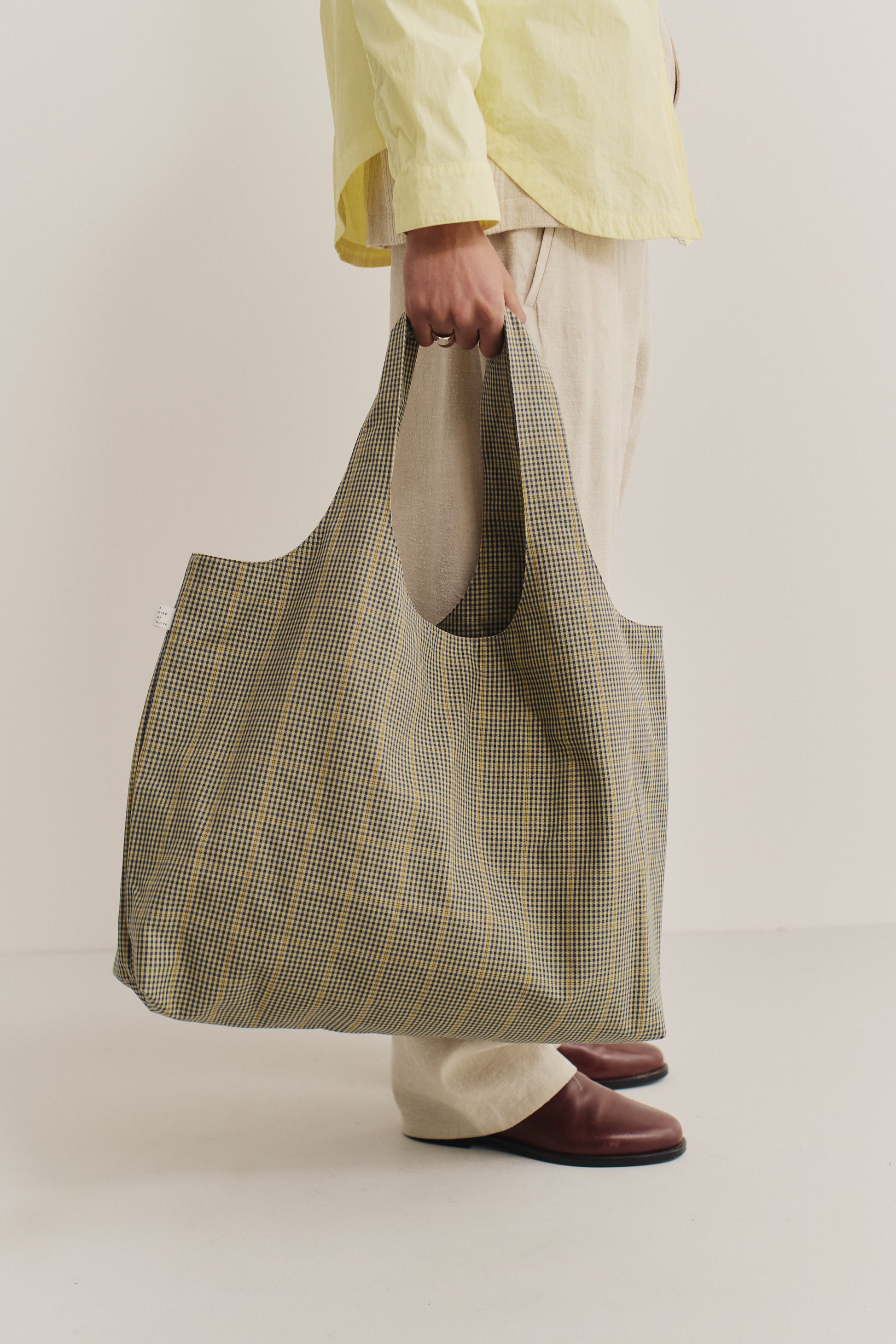 Women's accessories bag, cotton houndstooth in navy, green, and yellow on beige, spacious tote.