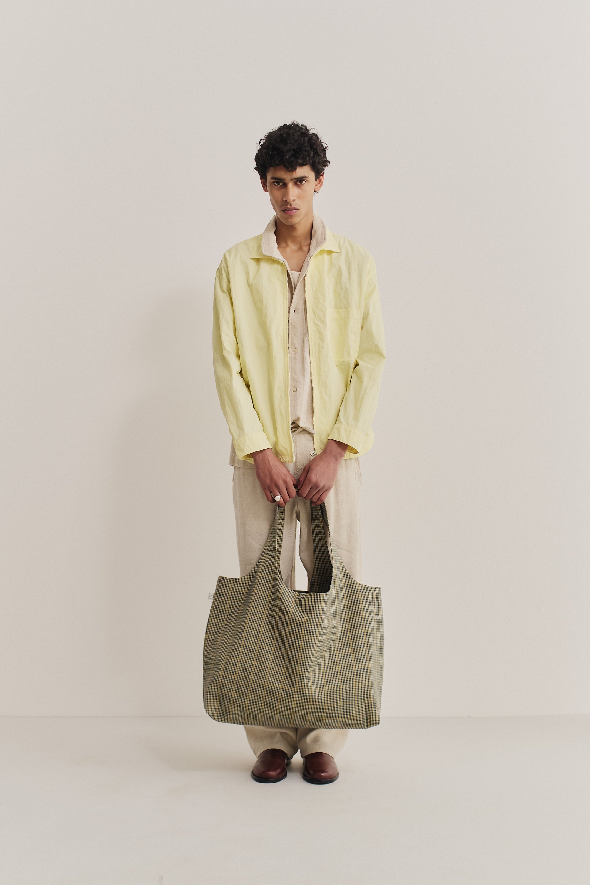 Women's accessories cotton Thika Bag, checkered houndstooth in navy, green, and yellow on beige.