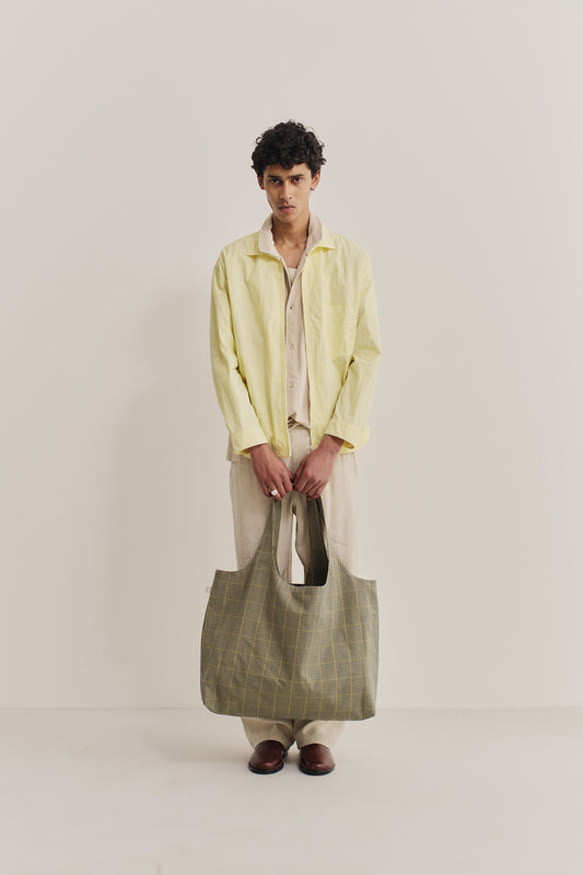 Women's accessories cotton Thika Bag, checkered houndstooth in navy, green, and yellow on beige.