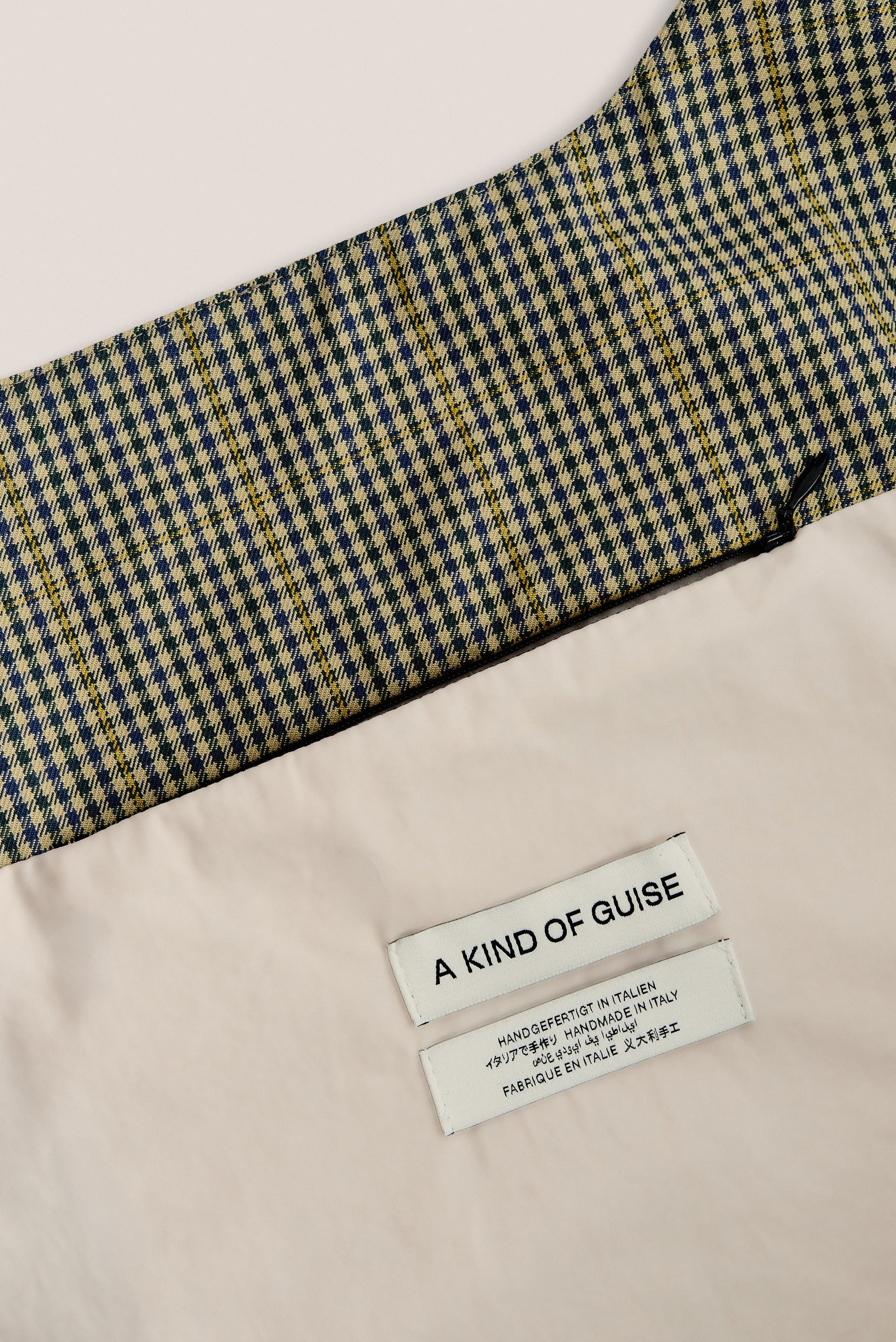 Women's accessories bag, cotton houndstooth in navy, green, and yellow on beige, with "A KIND OF GUISE" label.