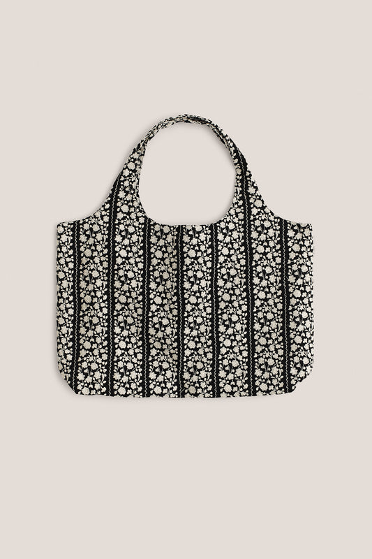 Women's accessories bag, 100% cotton, black with embroidered white flower blocks and wavy lines.