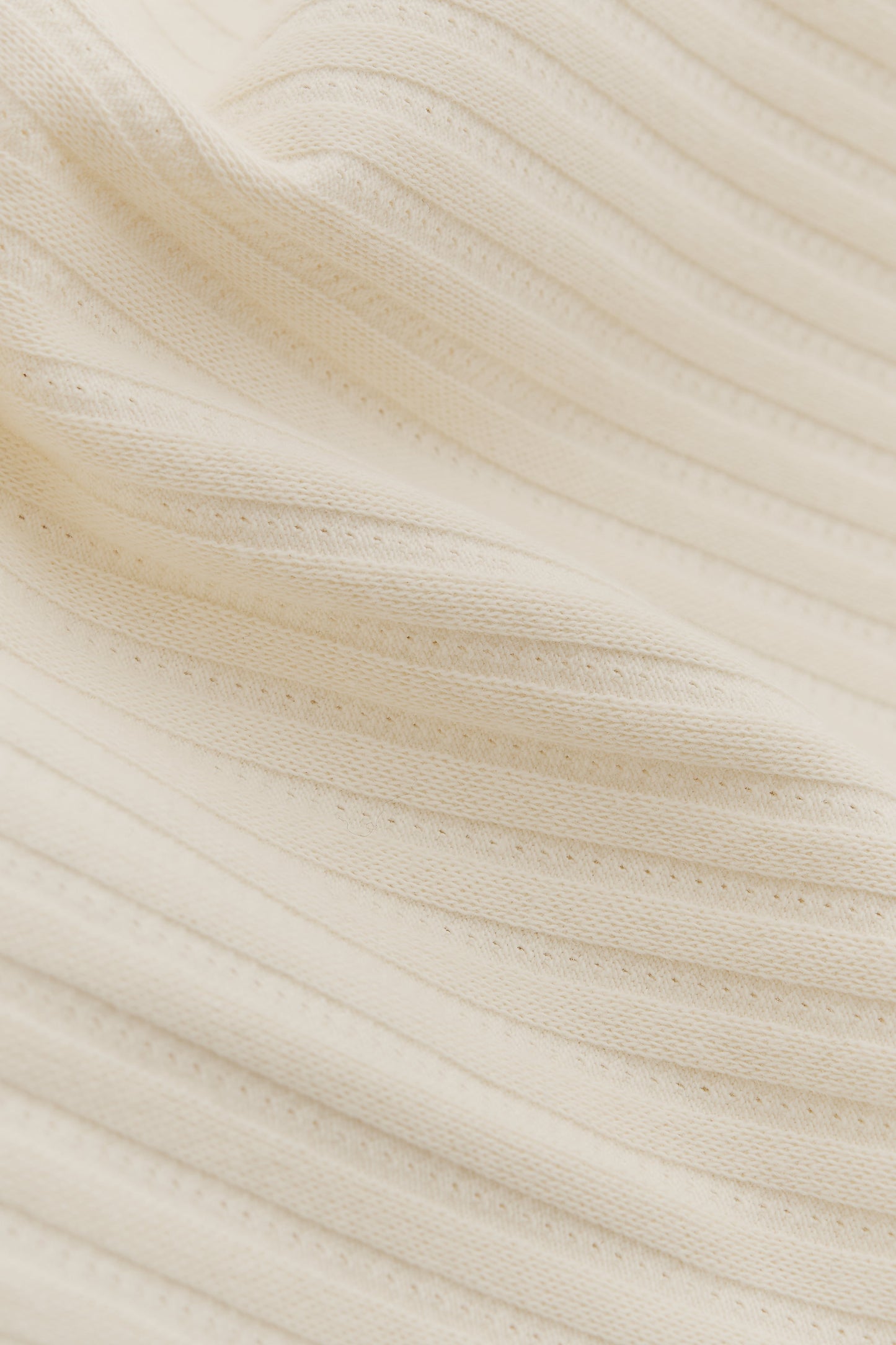 Unisex jersey tanktop, off-white cotton mix with rib structure and pointelle detailing.
