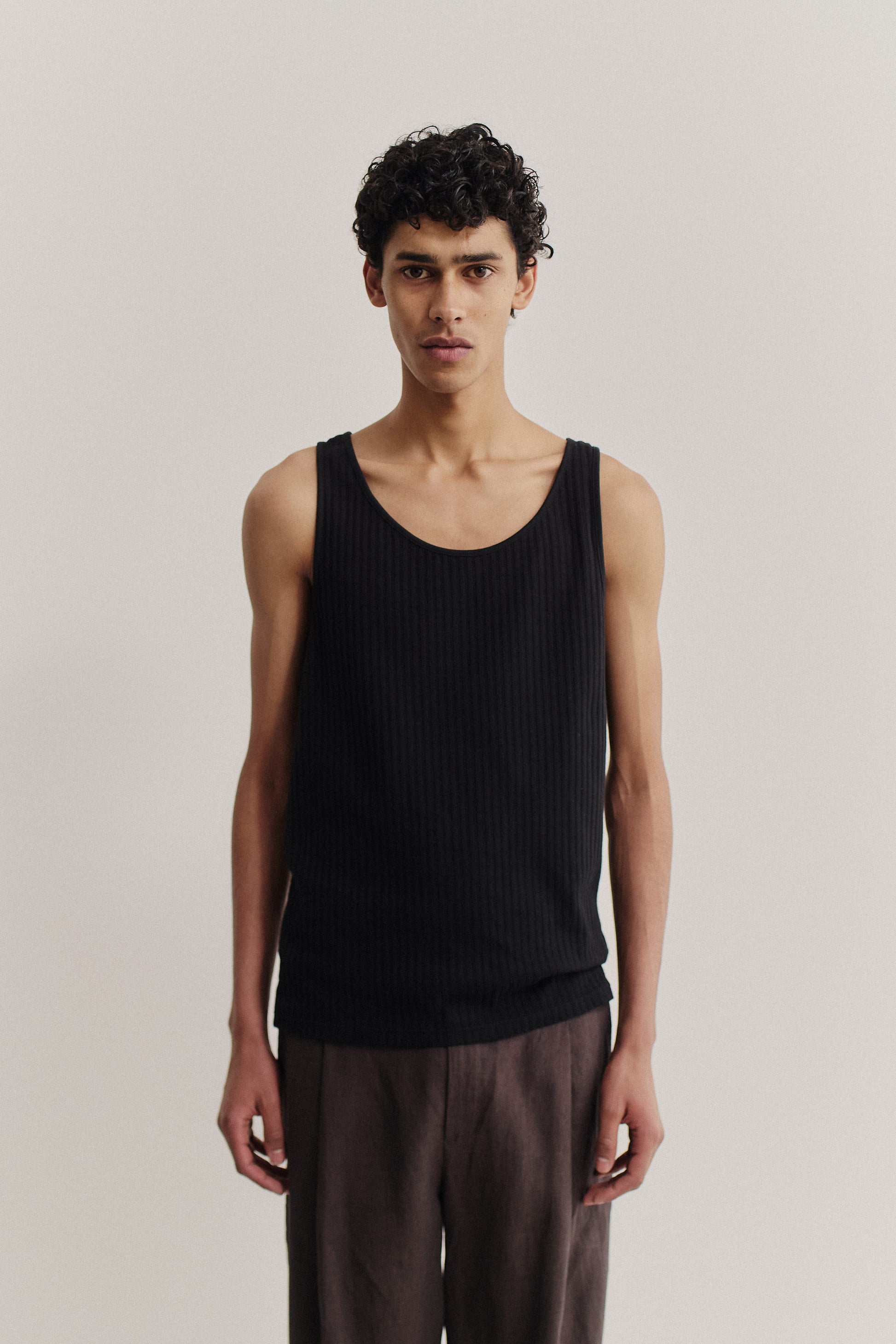 Men's jersey tanktop, cotton mix, garment dyed black, ribbed with pointelle detailing.