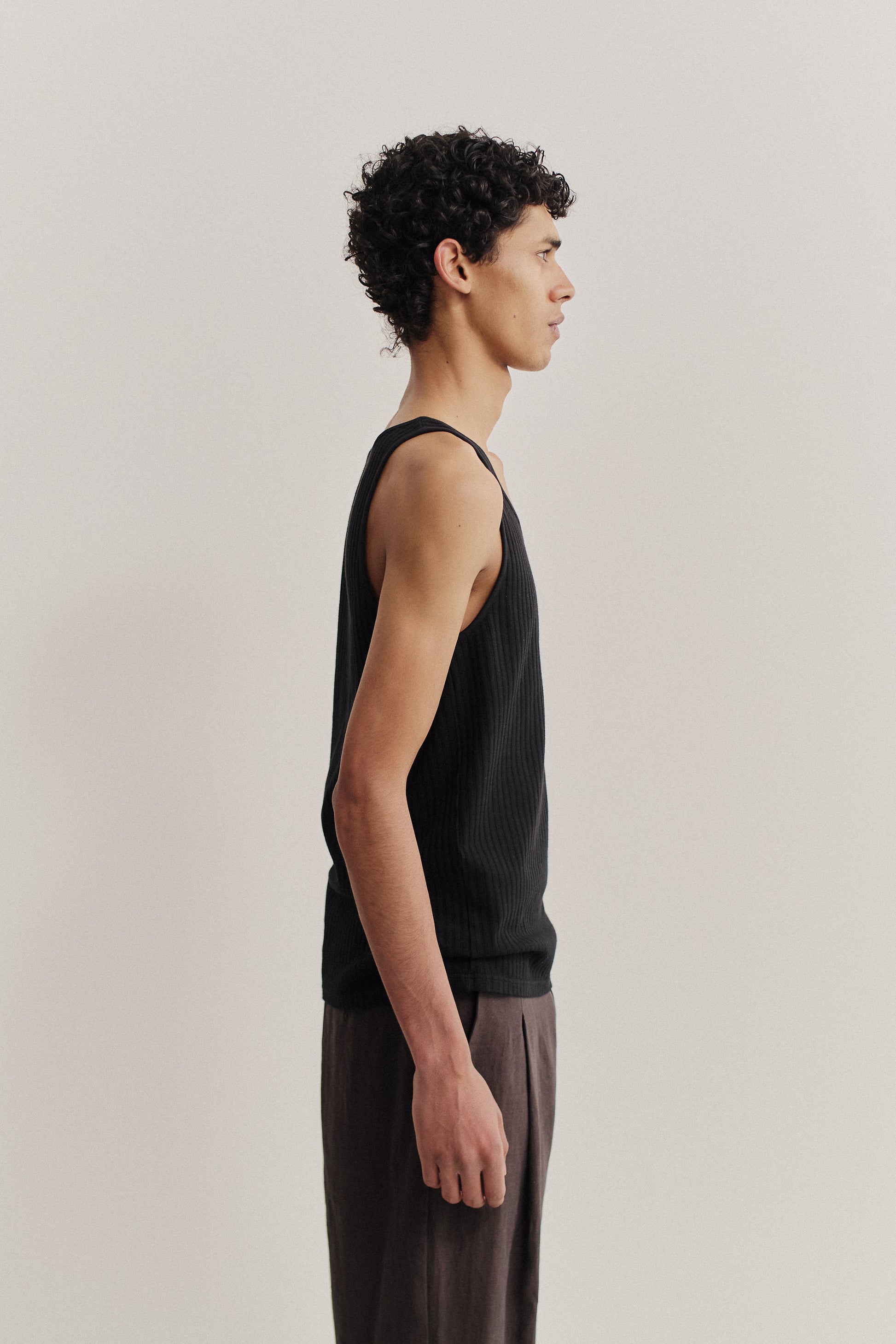 Men's jersey tanktop, garment dyed cotton mix, black, with rib structure and pointelle detailing.