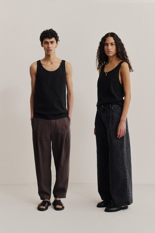 Unisex jersey tanktop, cotton mix, garment dyed black, with rib structure and openwork detailing.
