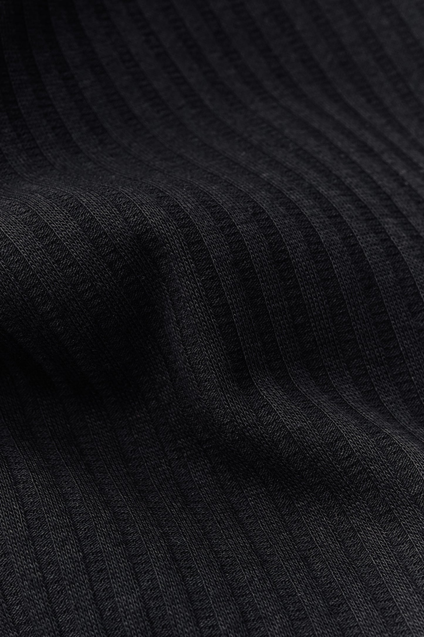 Unisex jersey tanktop, cotton mix, garment dyed, black, with rib structure and delicate openwork detailing.