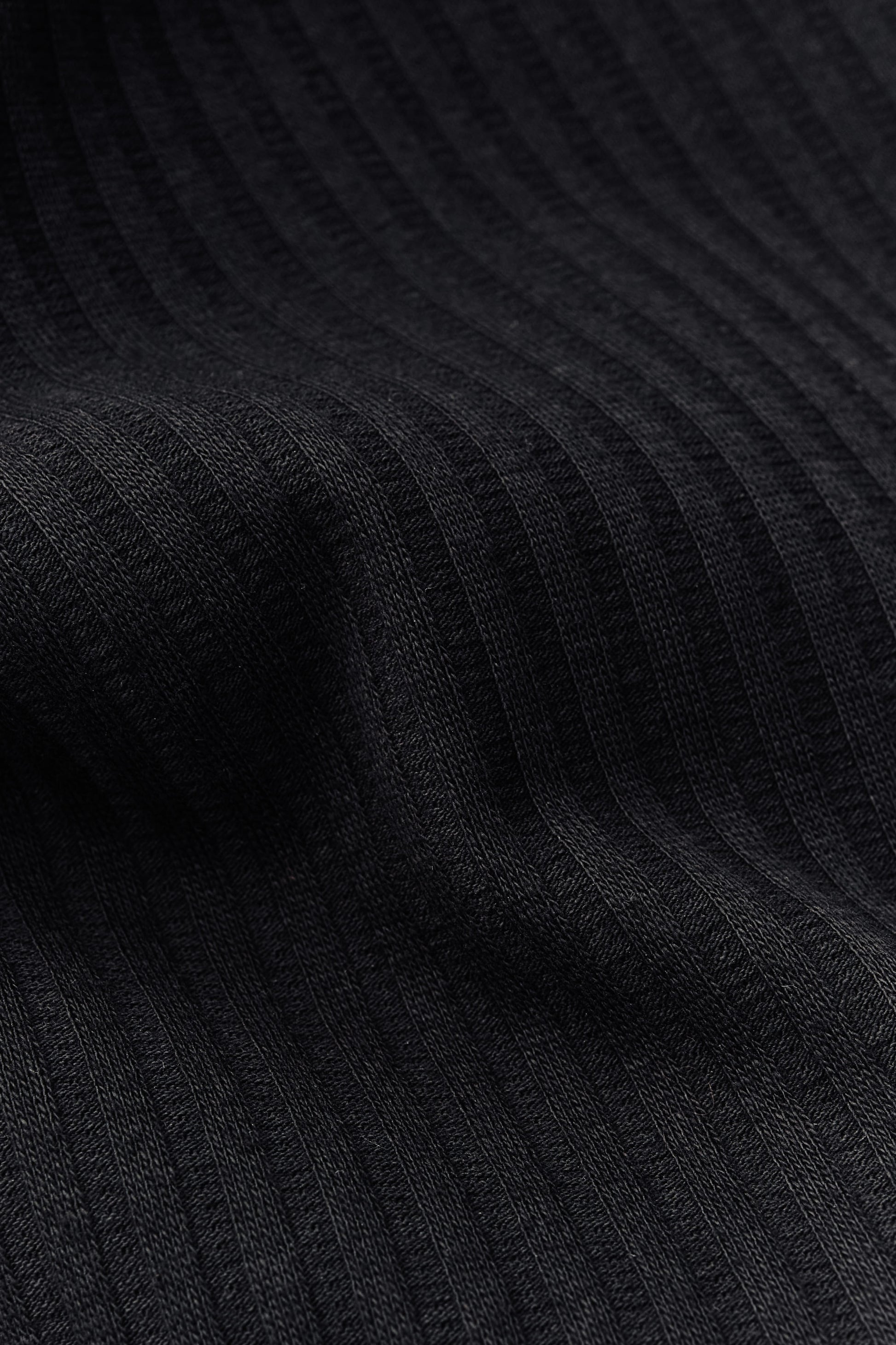 Unisex jersey tanktop, cotton mix, garment dyed, black, with rib structure and delicate openwork detailing.