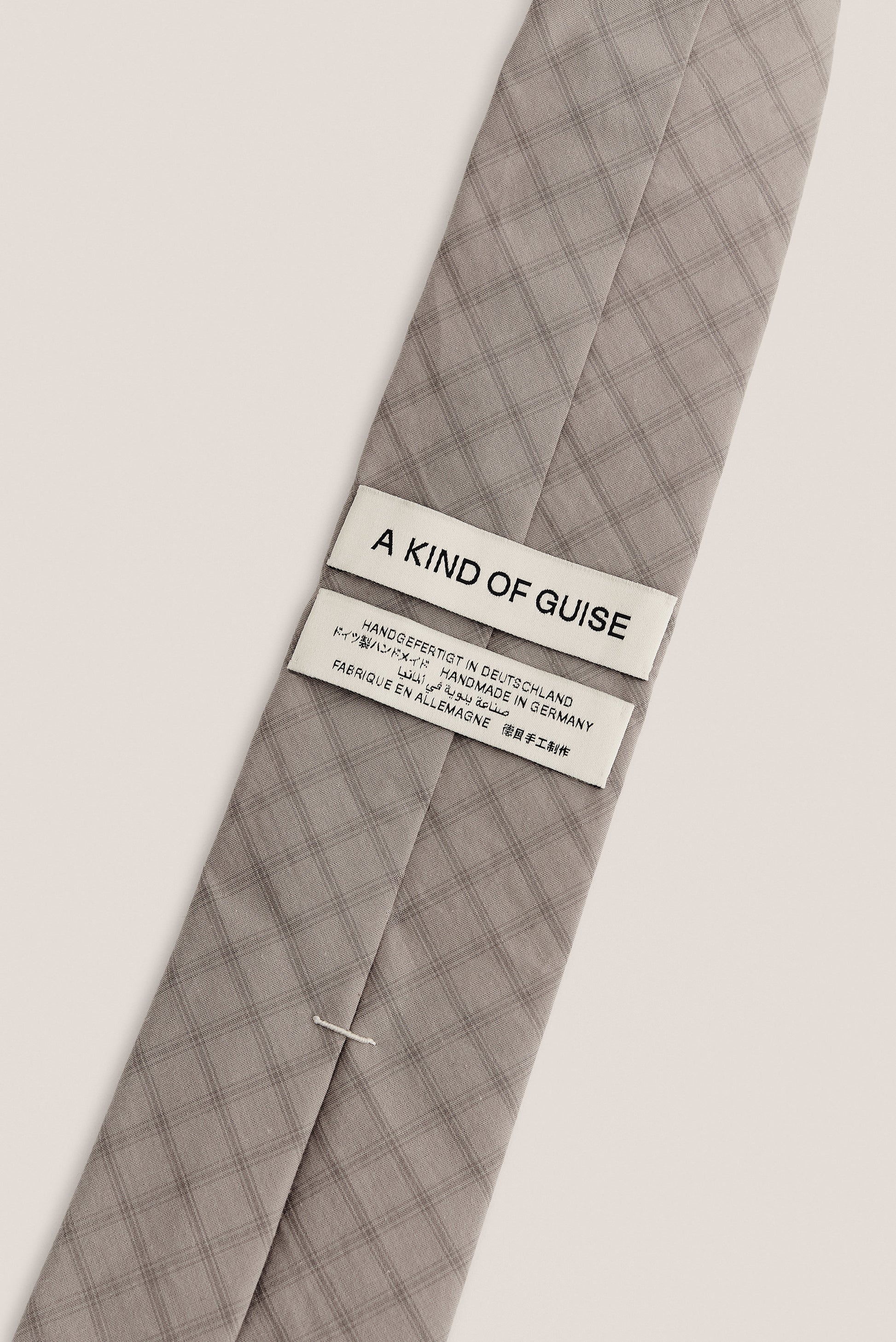 Men's accessories tie, 100% organic cotton, light grey with dark grey squared check pattern.