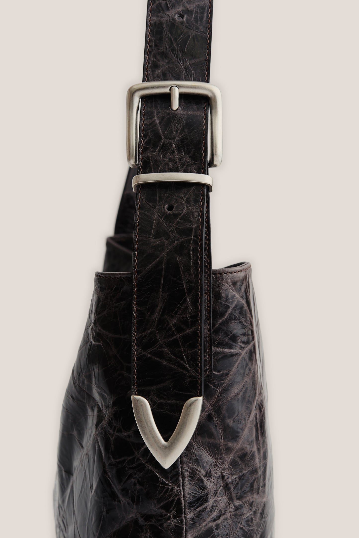 Men's accessories leather messenger bag with adjustable belt buckle strap, dark brown LWG-certified calf leather.