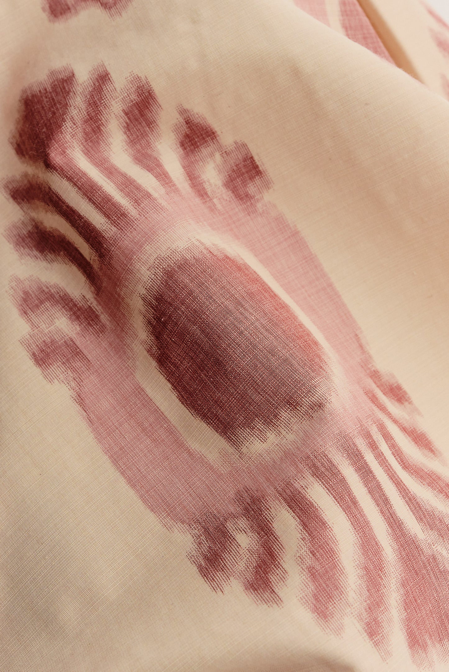 Men's shorts, cotton and recycled polyester blend, lightweight, off-white with red ikat-inspired pattern.