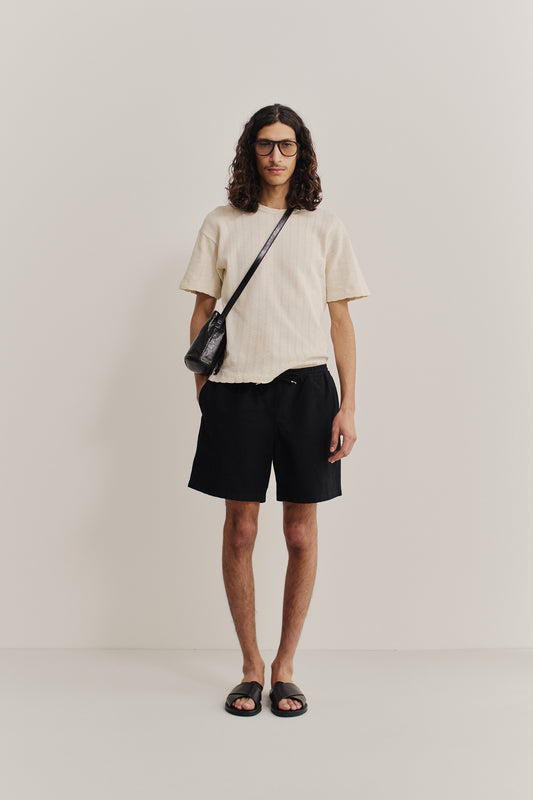 Men's shorts, worsted wool and linen blend, black, with adjustable waistband and side pockets.