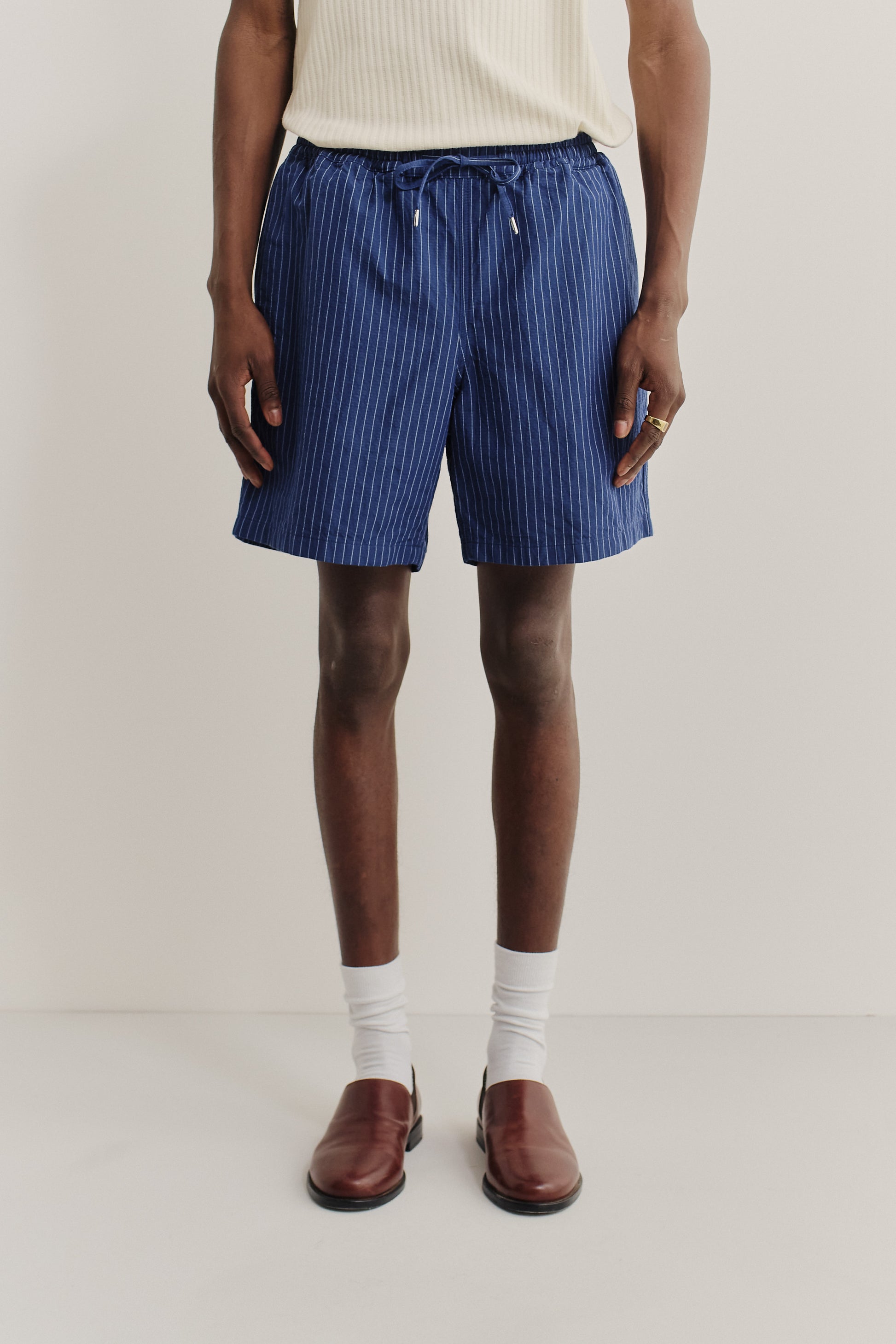 Men's shorts, cotton-linen seersucker, navy with white pinstripes, adjustable waistband.