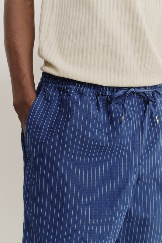 Men's shorts, cotton-linen seersucker, navy with white pinstripes, elastic waist with pull cords, side pockets.