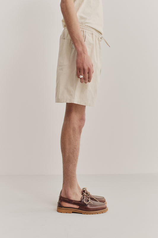 Men's shorts, cotton blend ripstop, waxed finish, light beige, with side pockets and drawstring waist.