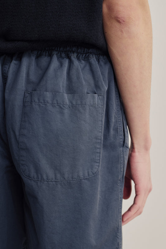 Men's shorts, cotton-linen blend, garment dyed, navy, with a single back patch pocket and elastic waist.
