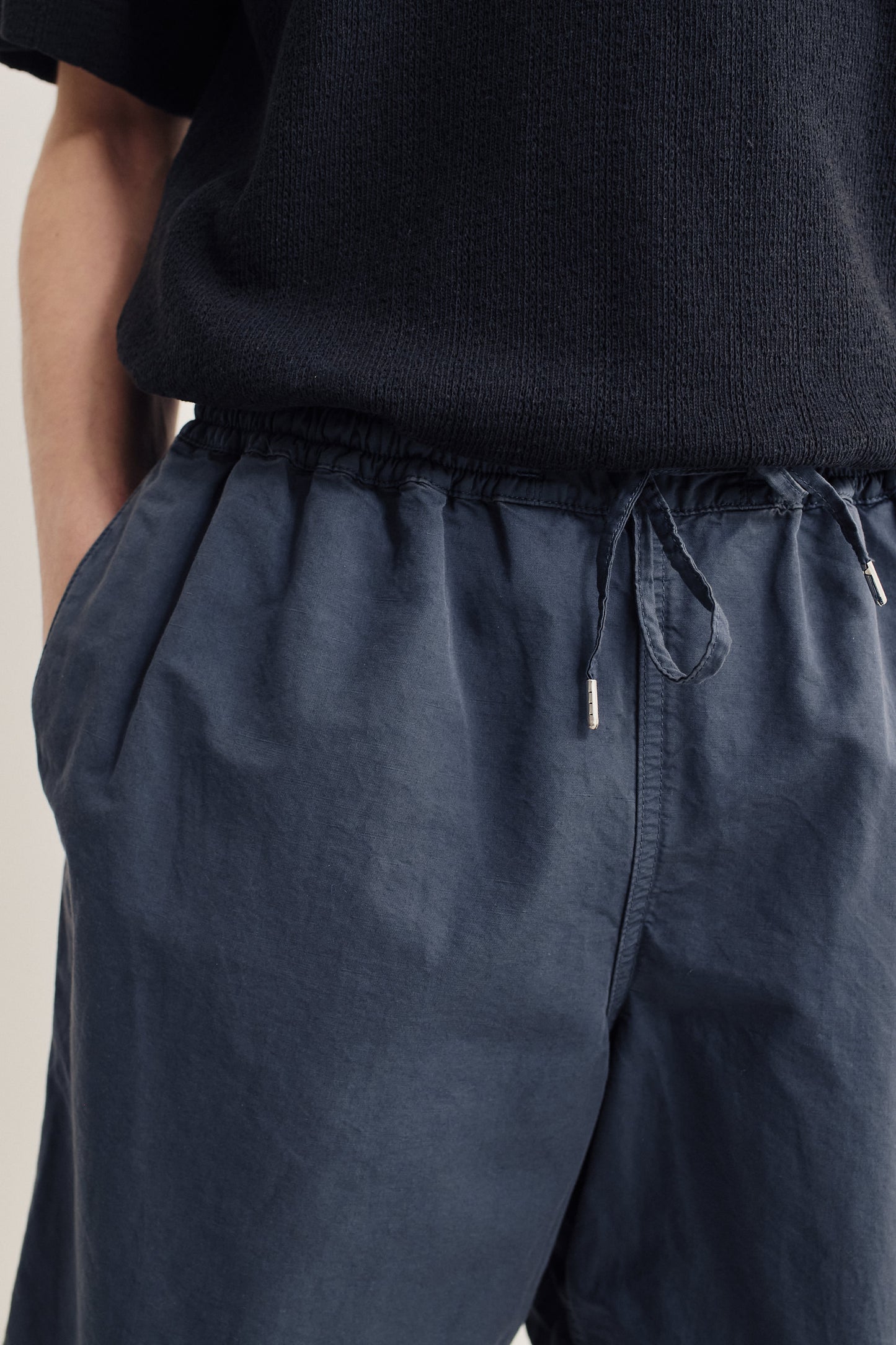 Men's shorts, cotton-linen blend, garment-dyed navy, with adjustable drawstring waist and side pockets.