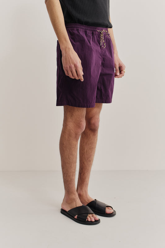 Men's shorts, recycled polyamide, garment-dyed purple, with adjustable waistband and side pockets.