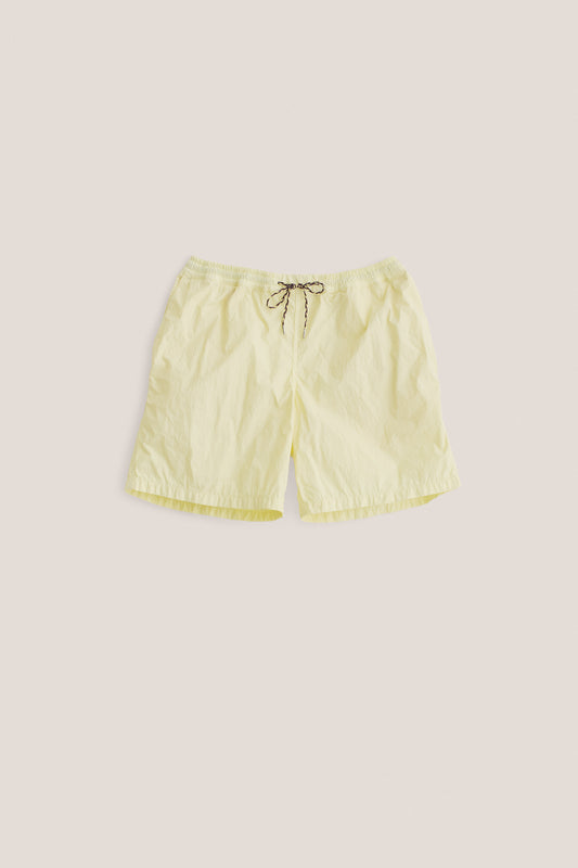 Men's shorts, recycled polyamide, garment-dyed light yellow, with adjustable waistband and pull cords.