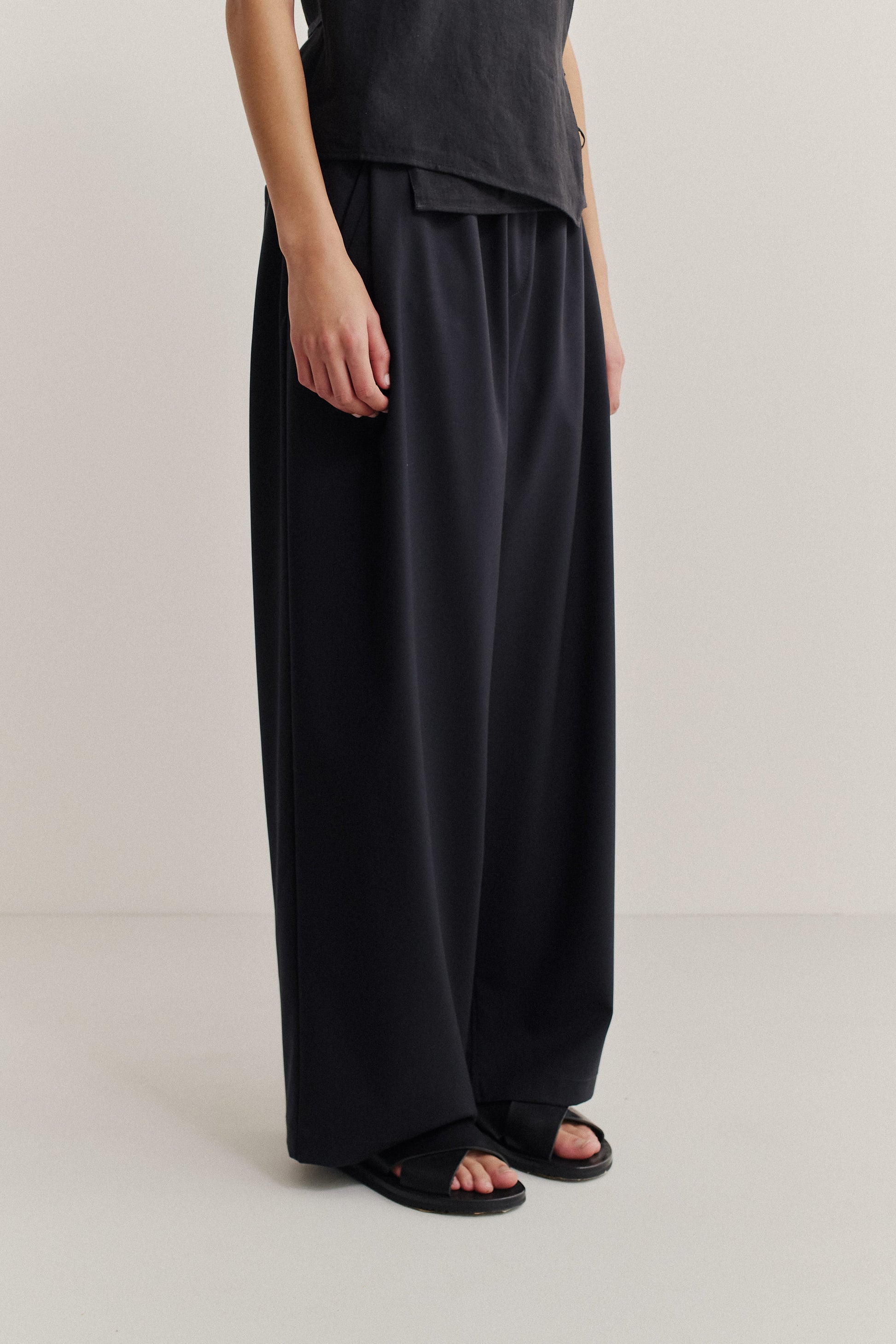 Unisex long-pants, virgin wool mohair, dark navy, wide leg, front pleat, and slanted welt pockets.