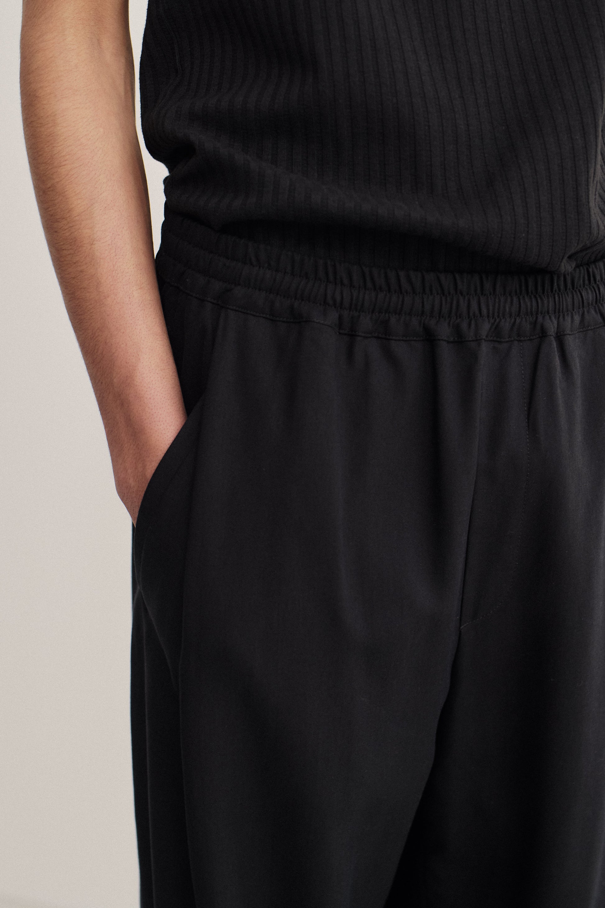 Men's long pants, lyocell heavy twill, black, elastic waist, wide leg, front pleat, slanted welt pockets.