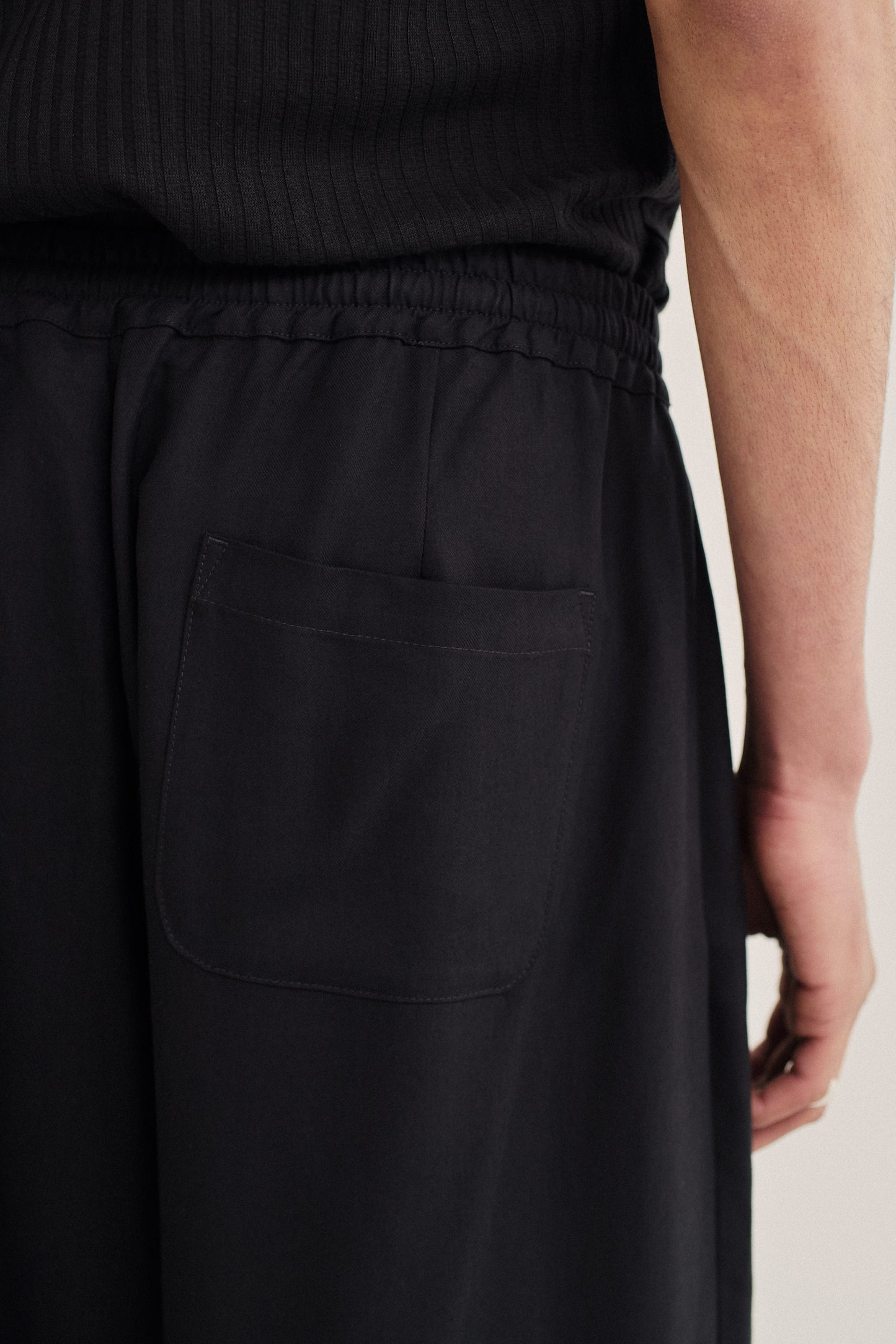 Men's pants, long-pants, lyocell twill, black, with elastic waistband and back patch pocket.