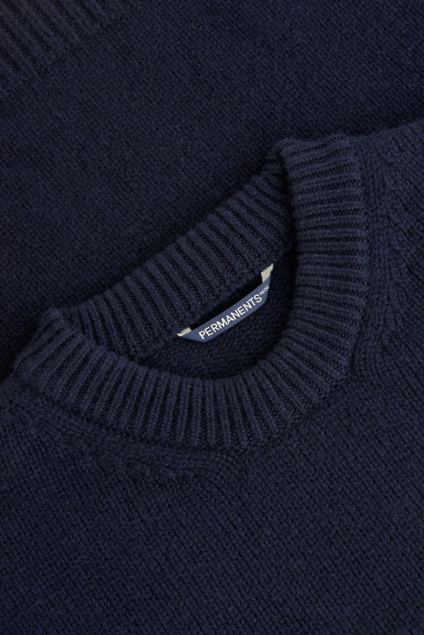 Men's knit pullover, navy merino wool-cashmere blend, with ribbed neck and PERMANENTS® label.