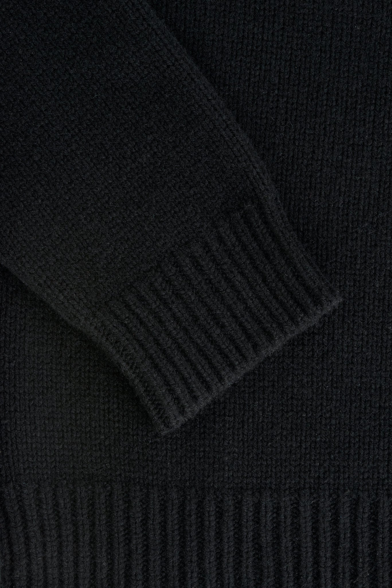 Men's knit pullover, black merino wool-cashmere blend, with ribbed cuff and hem details.