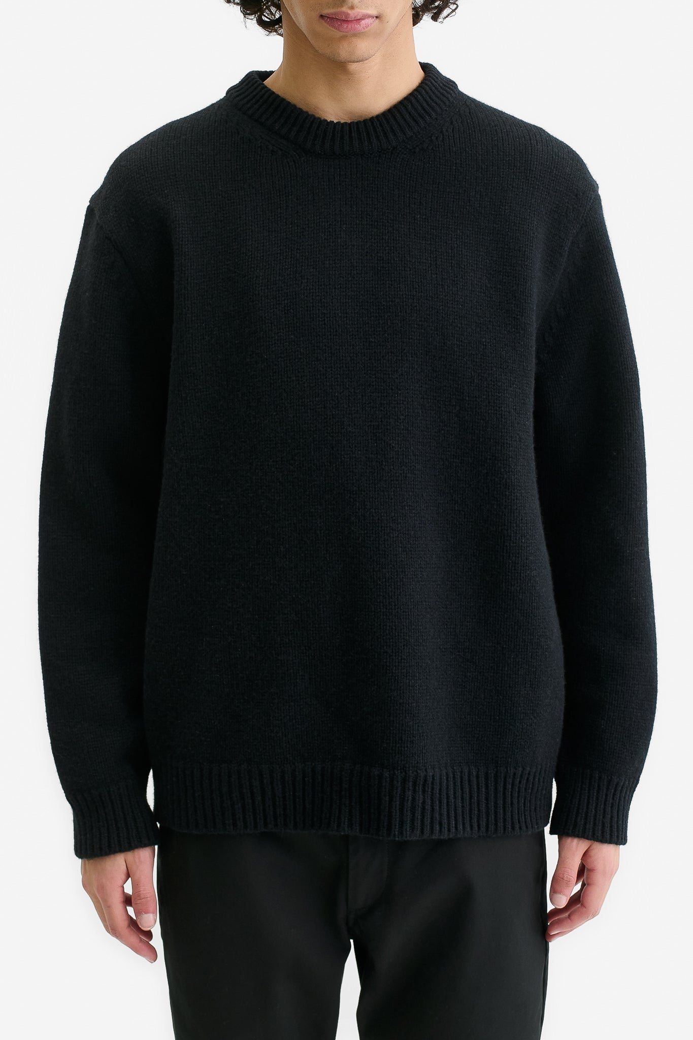Men's knit pullover, black merino wool-cashmere blend, relaxed fit, rib-knit neck, cuffs, and hem.