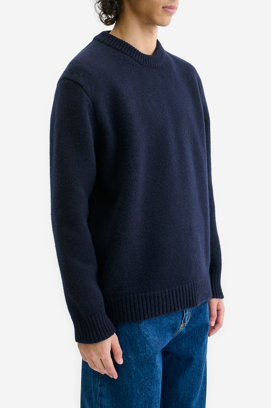 Men's knit pullover, navy merino wool-cashmere blend, relaxed fit, rib-knit details.