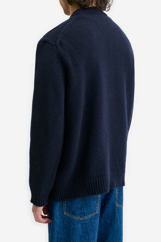 Men's knit pullover, navy merino wool-cashmere blend, relaxed fit, rib-knit details.
