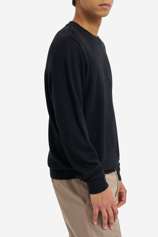 Men's knit crewneck, black mulesing-free merino wool, with rib-knit neck, cuffs, and hem.