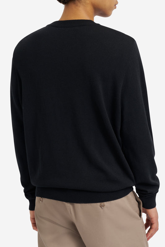 Men's knit crewneck, black mulesing-free merino wool, with rib-knit neck, cuffs, and hem.